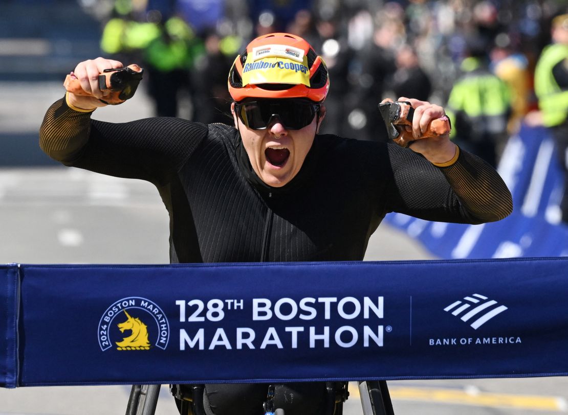 Rainbow-Cooper crosses the finish line to win the women's wheelchair race.