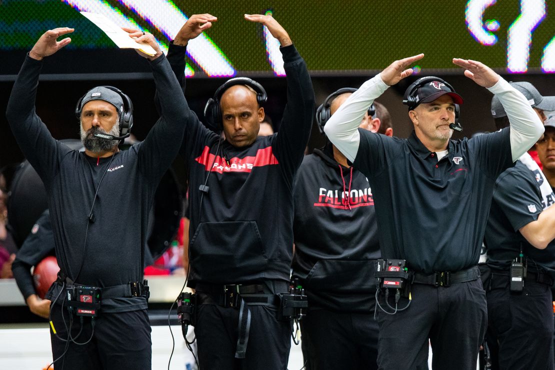 Durde (middle) got his first full-time coaching job on the Atlanta Falcons under then-head coach Dan Quinn.