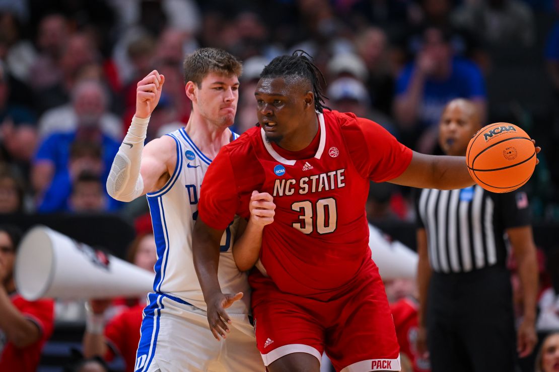 DALLAS, TEXAS - MARCH 31: DJ Burns Jr. #30 of the North Carolina State Wolfpack backs down Kyle Filipowski #30 of the Duke Blue Devils during the Elite Eight round of the 2024 NCAA Men's Basketball Tournament held at American Airlines Center on March 31, 2024 in Dallas, Texas. (Photo by Andy Hancock/NCAA Photos/NCAA Photos via Getty Images)