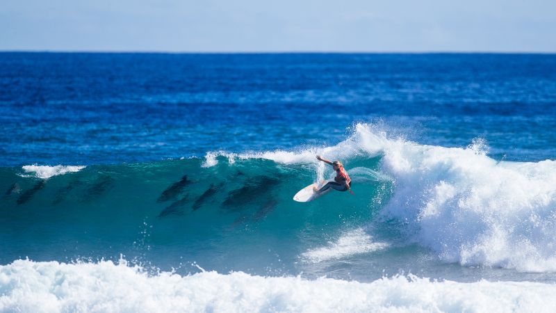 ‘Magical’ moment as surfer shares wave with pod of dolphins as she wins first world championship tour event