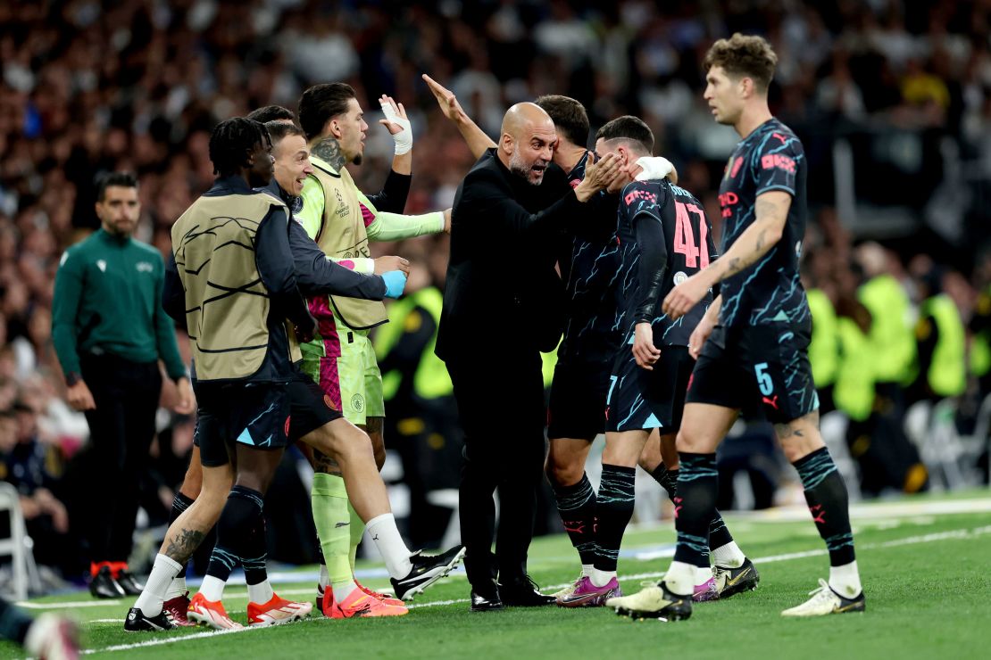 Manchester City manager Pep Guardiola celebrates with Phil Foden after the forward scored a stunning goal.