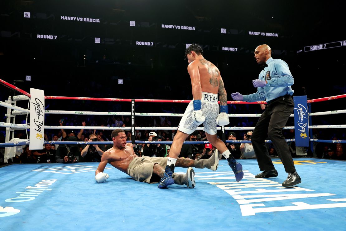 Ryan Garcia knocks down Devin Haney during their WBC super lightweight title bout at Barclays Center on April 20, 2024 in New York City.