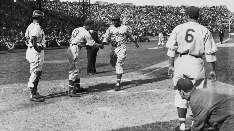 Robinson crosses home plate after hitting a three-run home run for the Montreal Royals in 1946.