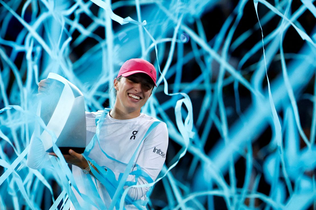 Świątek celebrates winning the Madrid Open after defeating Aryna Sabalenka.