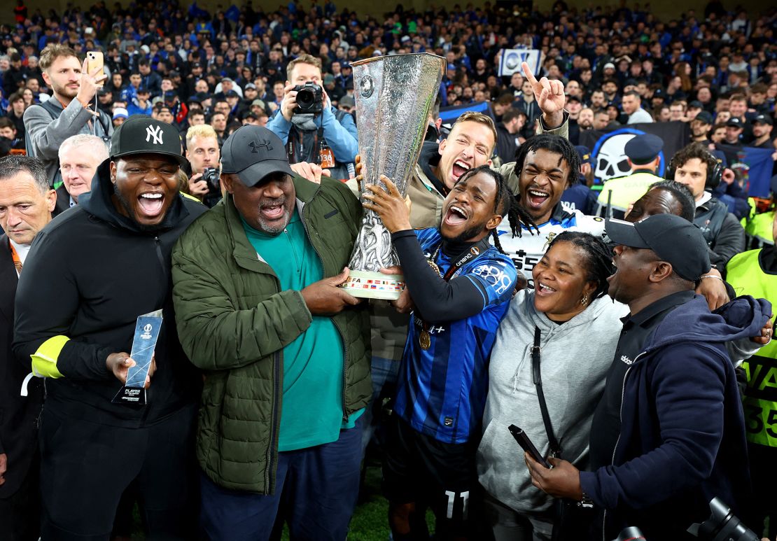 Lookman celebrates with the Europa League trophy.