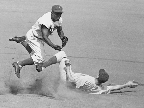 Robinson leaps into the air to try to turn a double play in 1952.