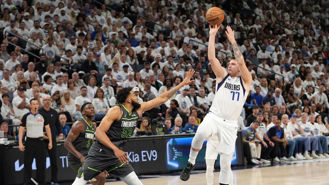 Dallas Mavericks guard Luka Dončić shoots over Minnesota Timberwolves center Karl-Anthony Towns during Game 5 of the Western Conference finals.