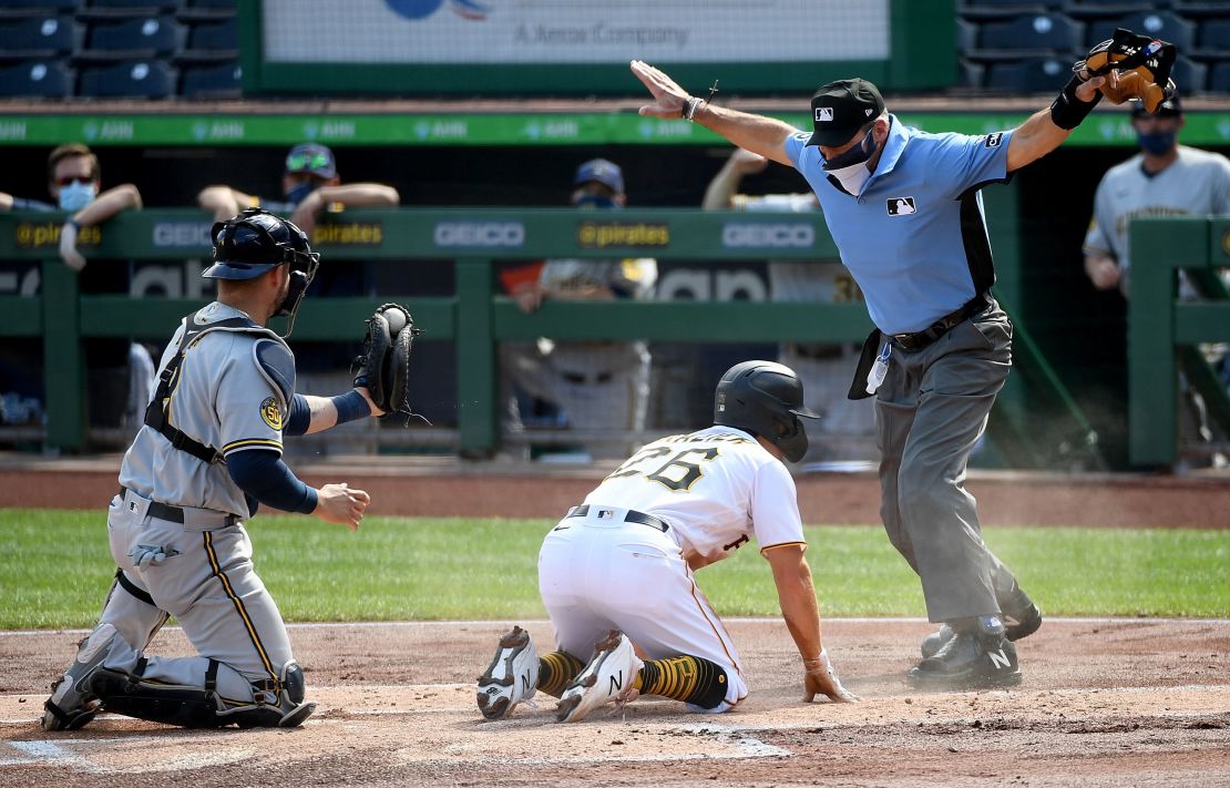 Hernández calls Adam Frazier of the Pittsburgh Pirates safe after a play at the plate during a game against the Milwaukee Brewers.