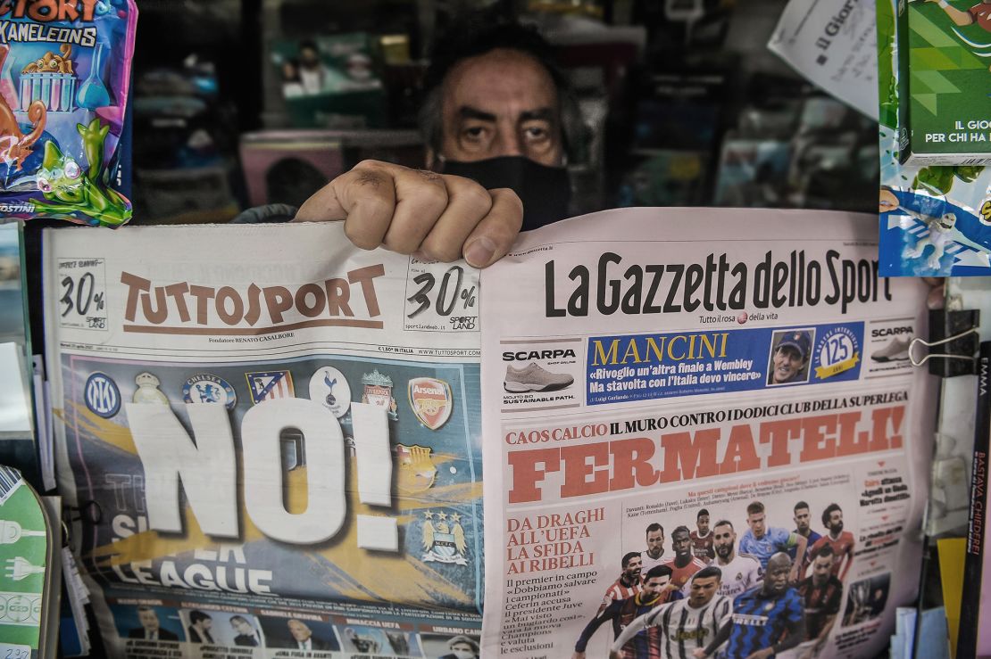 A newsagent shows two pages of the main Italian sports newspapers with a headline regarding the Super League reading 'No!' and 'Fermateli!' ('Stop them!).