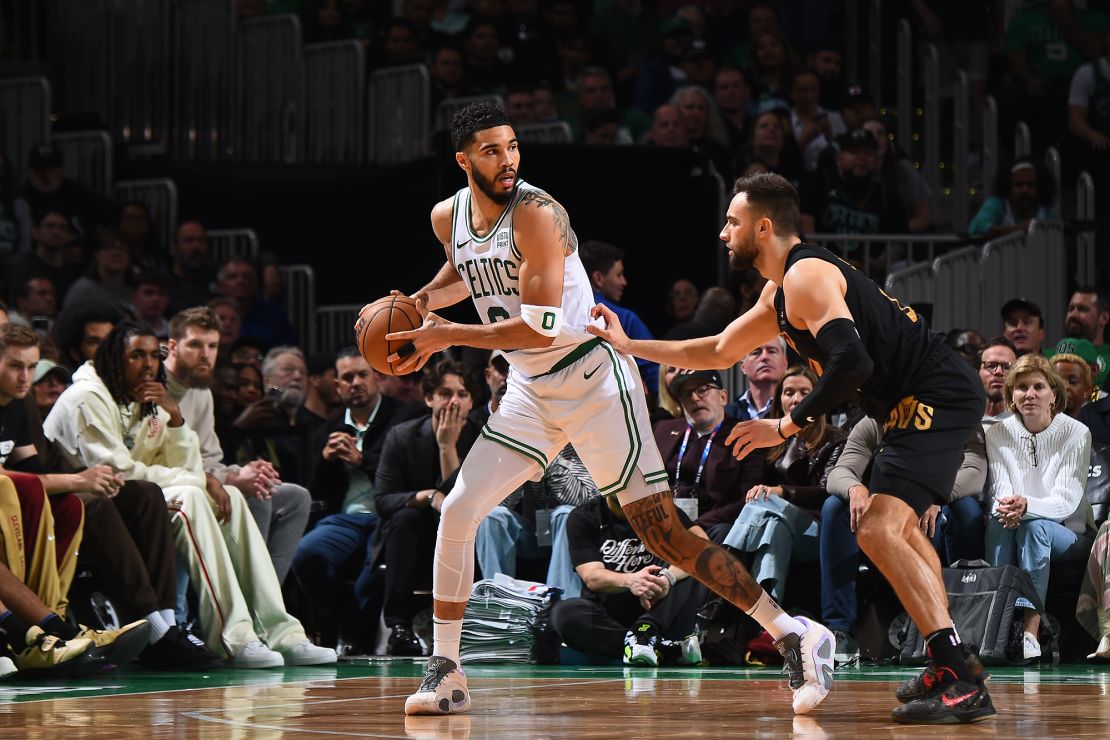 Tatum is defended by Max Strus during the game.