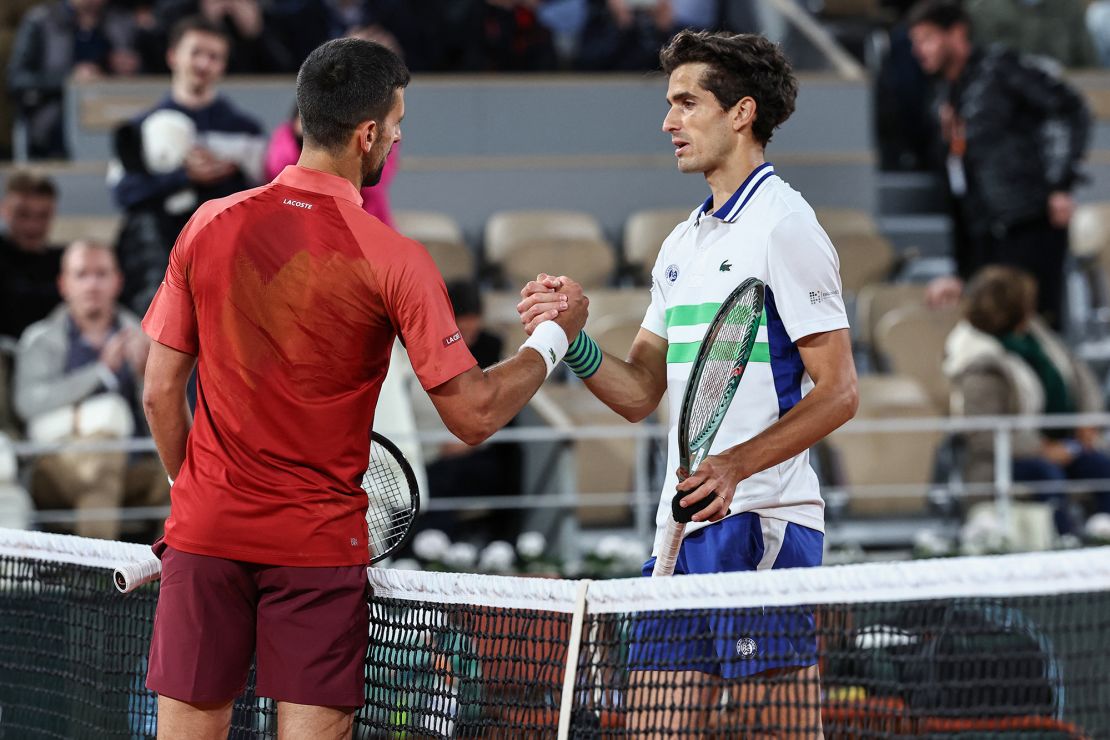 Djokovic shakes hands with France's Pierre-Hugues Herbert after winning, at the end of their men's singles match on Court Philippe-Chatrier on day three of the French Open tennis tournament.