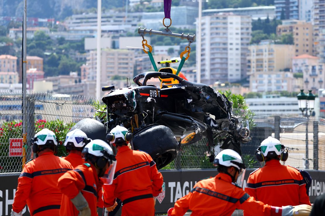 Sergio Pérez's car was recovered from the track after he crashed in the first lap.