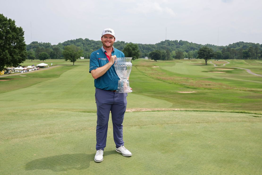 Higgs poses with the trophy after winning the Visit Knoxville Open.