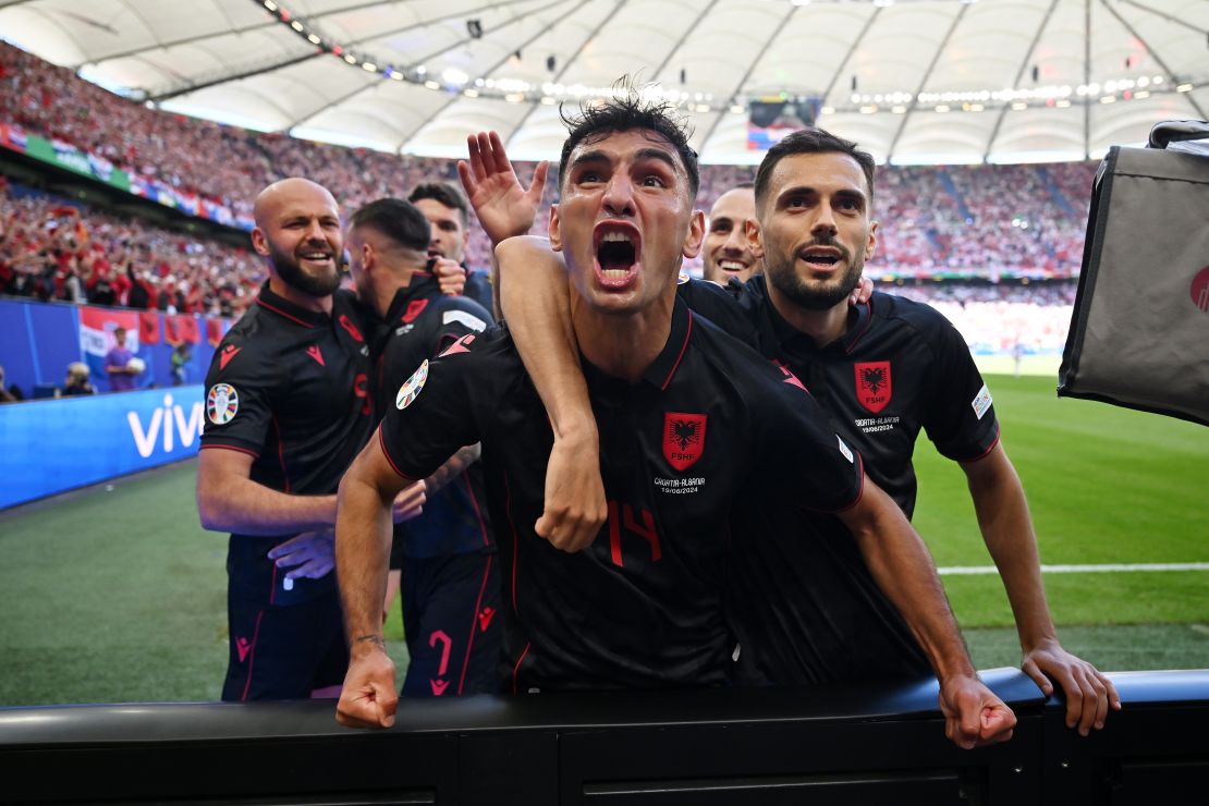 Albania players celebrate scoring the first goal of the game.