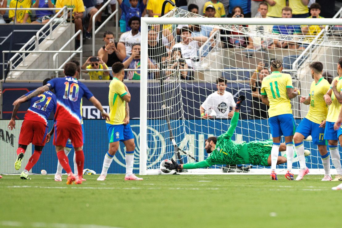 Pulisic scores a goal past Brazil goalkeeper Alisson.