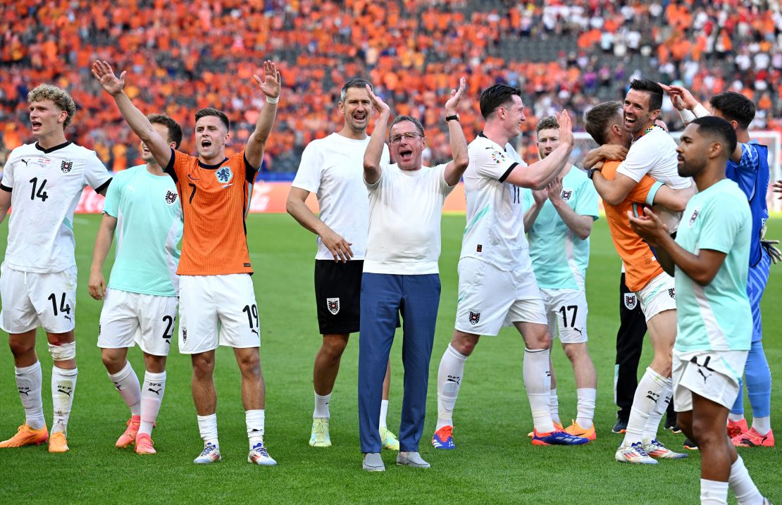 Austria coach Ralf Rangnick and players celebrate after beating the Netherlands.