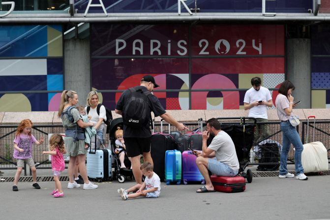 Travellers from Sydney wait outside the Gare Montparnasse train station on Friday. Just hours before the opening ceremony, <a href="https://www.cnn.com/sport/live-news/paris-olympics-2024-opening-ceremony-seine#h_3e01b5ed3f2771f05d04f206fbffd246">France’s high-speed train lines were targeted by several “malicious” acts</a>, including arson, in what has been described as “coordinated sabotage” to disrupt travel ahead of the Games. An estimated 800,000 travelers could be affected over the weekend.