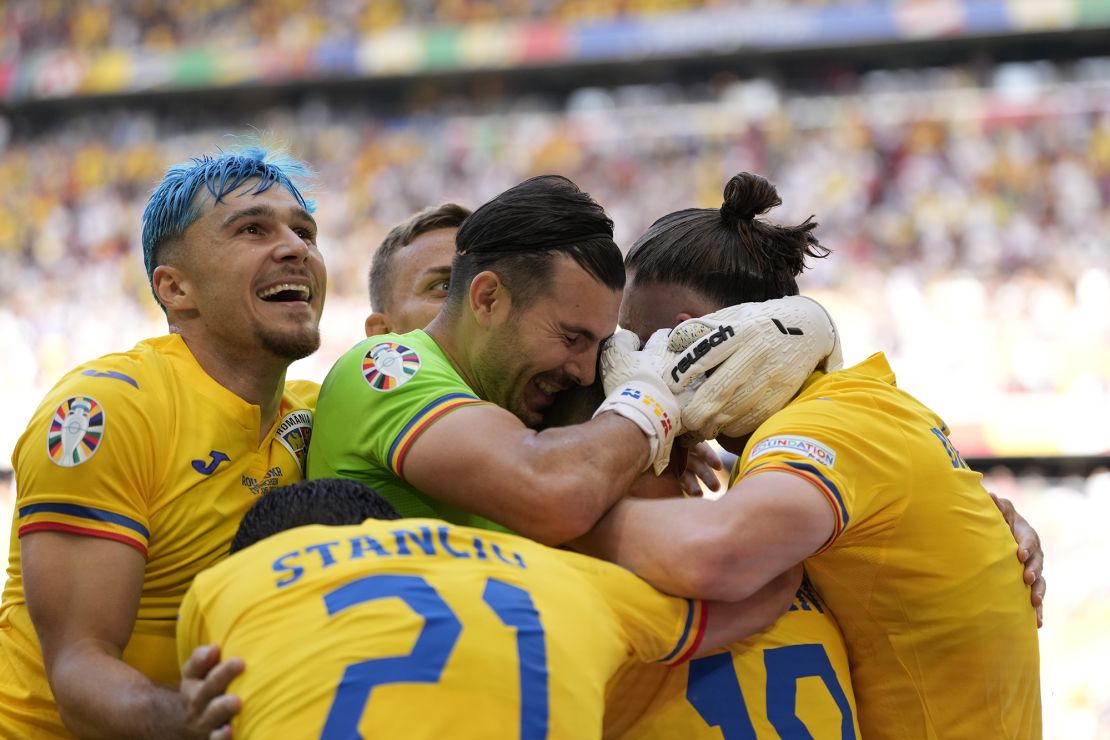 Romania's players celebrate during their victory against Ukraine on Monday.