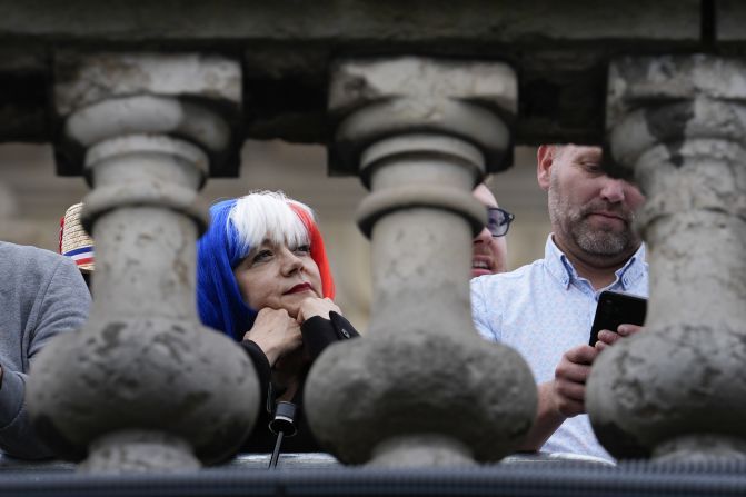 Fans watch the ceremony near the Seine River.