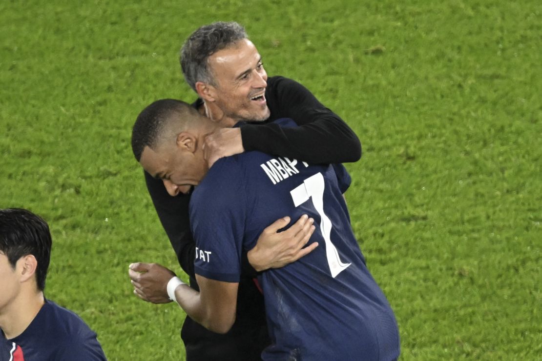 Mbappé celebrates with PSG head coach Luis Enrique after PSG defeated AC Milan in the Champions League.