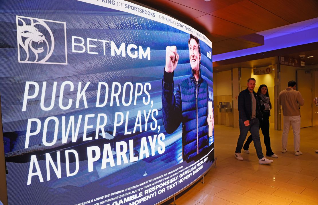 Fans walk past BetMGM signage featuring Wayne Gretzky prior to the game between the New York Rangers and the Carolina Hurricanes at Madison Square Garden on November 02, 2023 in New York City.