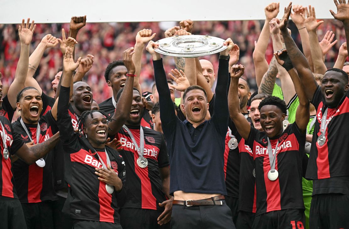 Alonso and his players celebrate with the Bundesliga trophy.