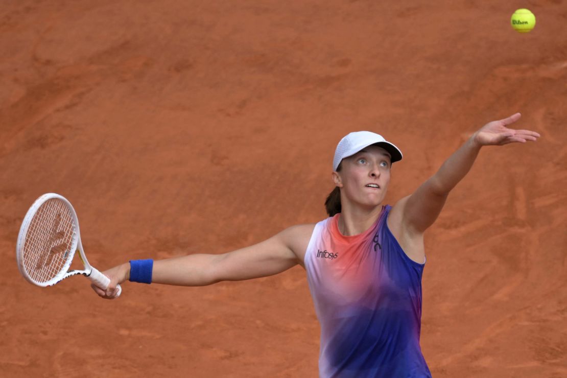 Świątek hits a serve against Paolini.