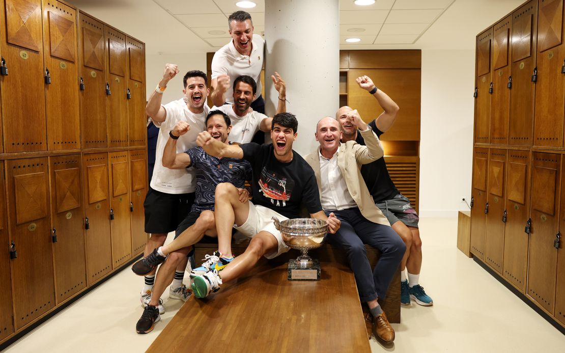 Alcaraz and his team pose for a photo in the locker room after winning the French Open.