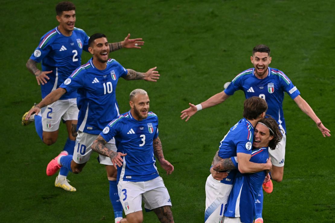 Barella celebrates with his teammates after scoring Italy's second.