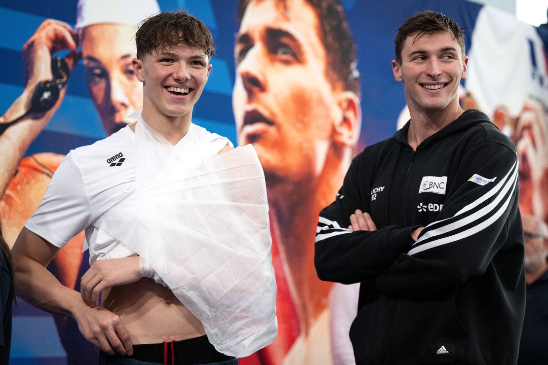 Grousset (right) and an injured Fente-Damers wait for their medals.