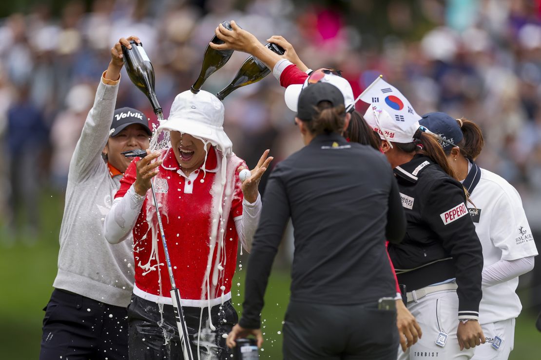 Yang is doused with champagne on the 18th green.