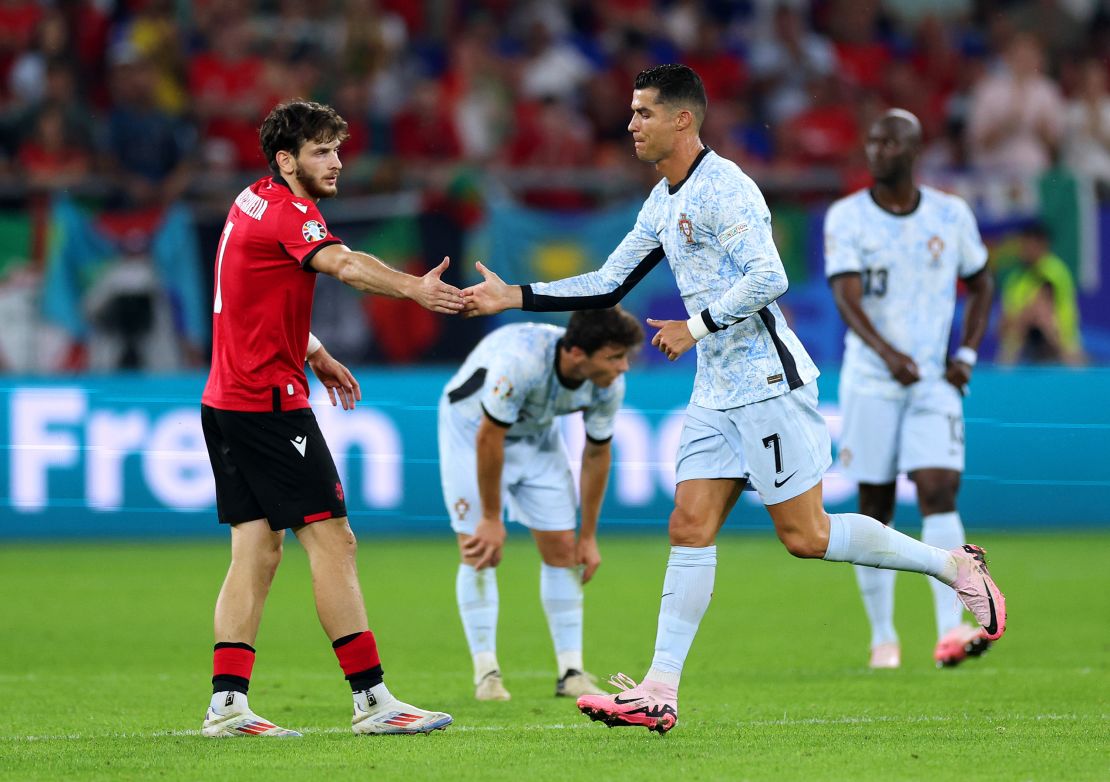 Cristiano Ronaldo shakes hands with Khvicha Kvaratskhelia as he was substituted off in the second half.