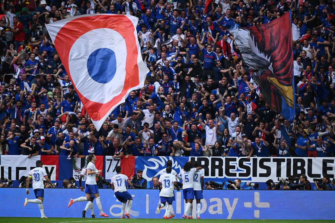 France players celebrate with their fans after scoring the only goal of the game to beat Belgium and advance to the quarterfinals of Euro 2024.