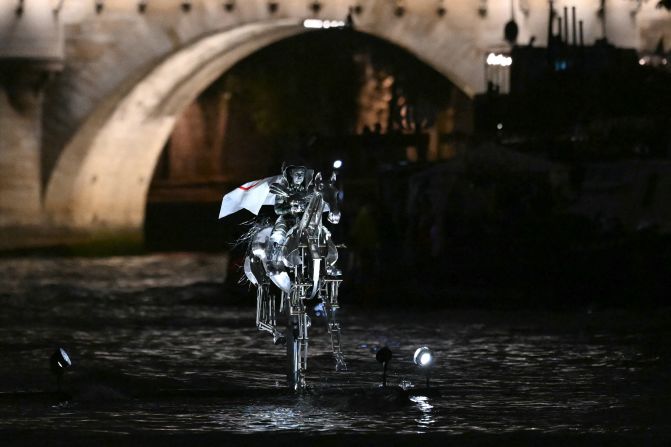 Issert wore the Olympic flag as she <a href="https://www.cnn.com/sport/live-news/paris-olympics-2024-opening-ceremony-seine#h_8b8665772097d280bfa8418324861f82">rode a metal horse aboard a boat that traveled down the Seine River.</a>