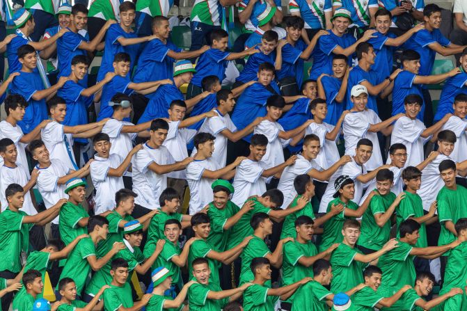 Uzbekistan fans chant together in the stands as they watch their men's soccer team play Egypt on July 27.