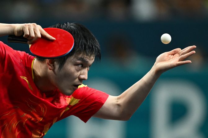 China's <a href="https://www.cnn.com/sport/live-news/paris-olympics-news-2024-08-04#h_67fb979428e918ce0a6a74ab9201edf8">Fan Zhendong</a> serves during the men’s singles table tennis final on August 4. He defeated Sweden’s Truls Möregårdh 4-1 to win the gold medal.