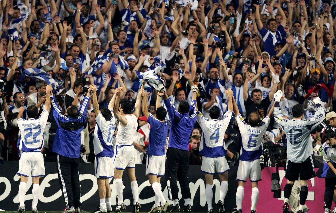 Greece players celebrate in front of the crowd after winning the tournament.