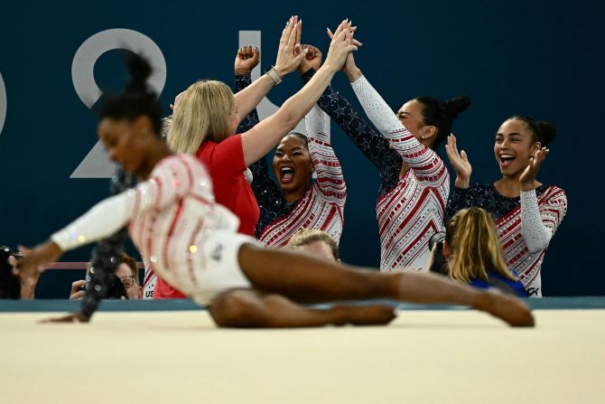 Team USA celebrates as Biles finishes her floor exercise at the end of the competition. Biles needed only 8.865 points to claim gold. <a href="https://www.cnn.com/sport/live-news/paris-olympics-news-2024-07-30#h_59cd26da520c536027d9d33c35f1e04a">She scored a 14.666</a>.