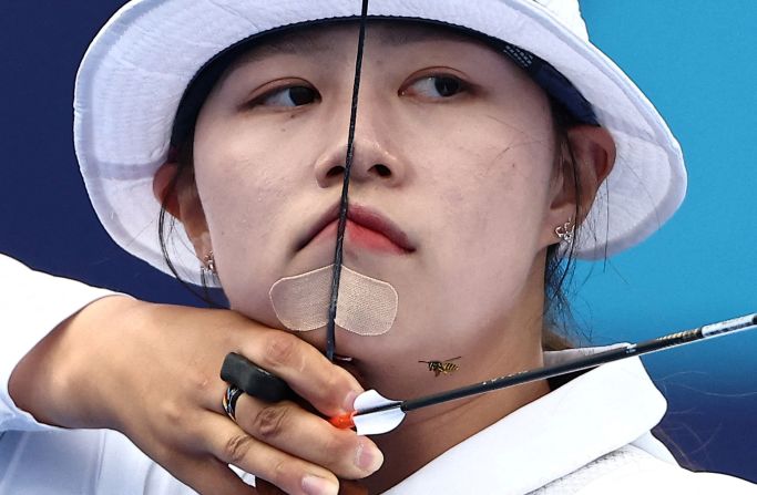 A bee flies near South Korean archer Lim Si-hyeon on August 3. <a href="https://www.cnn.com/sport/live-news/paris-olympics-news-2024-08-03#h_37b532ff67fdf499af43166393ec157c">She won the individual event</a> for her third gold medal in Paris.