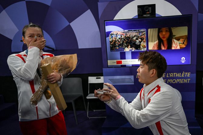 China's Liu Yuchen proposes to his teammate and girlfriend Huang Yaqiong as she left the podium after winning gold at the mixed doubles badminton medal ceremony on August 2.