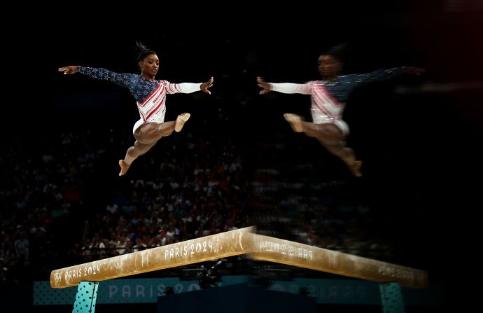 Biles competes on the balance beam. She had a few moments of catching her balance <a href="https://www.cnn.com/sport/live-news/paris-olympics-news-2024-07-30#h_4fced27f1f304f44221f03e4f1266107">but she finished it in typical fashion</a>, flipping through the air on her dismount to finish with a score of 14.366.