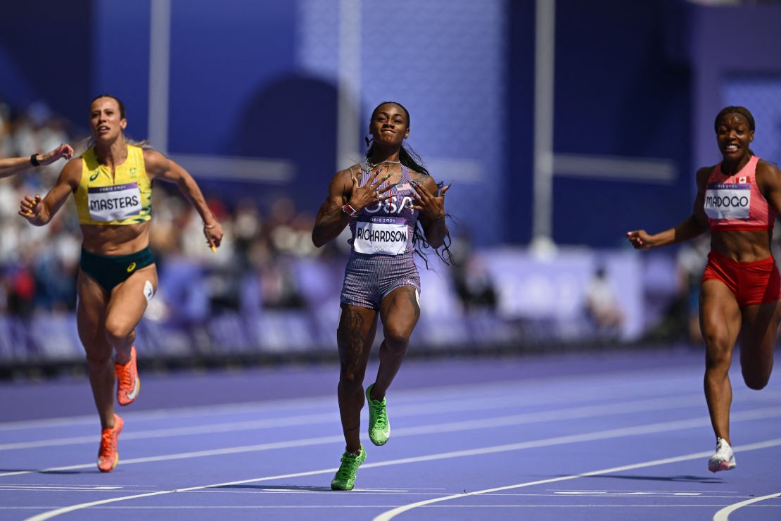 US' Sha'Carri Richardson (C) crosses the finish line to win past Australia's Bree Masters and Canada's Jacqueline Madogo in the women's 100m heat of the athletics event at the Paris 2024 Olympic Games at Stade de France in Saint-Denis, north of Paris, on August 2, 2024.