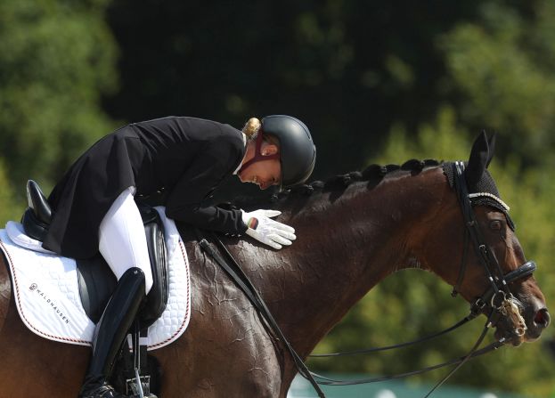 Germany's Jessica Von Bredow-Werndl pets her horse TSF Dalera BB after competing in the equestrian dressage individual grand prix on August 4. She <a href="https://www.cnn.com/sport/live-news/paris-olympics-news-2024-08-04#h_e279e4f7faf98573692a09d50fdebccb">won the gold medal</a>.