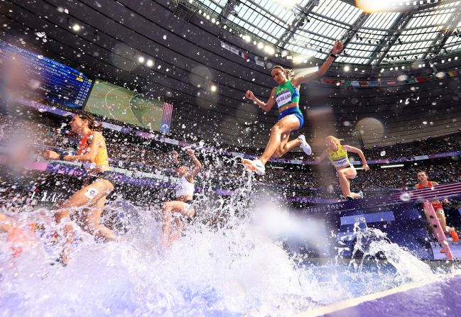 Athletes compete in the women's 3,000-meter steeplechase on August 4.