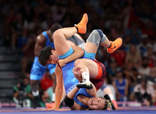 Kyrgyzstan's Meerim Zhumanazarova, top, wrestles Mongolia's Enkhsaikhan Delgermaa on August 5.