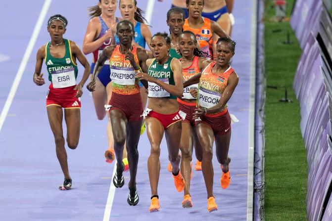 Kenya's Faith Kipyegon, right, fights for the lead during the 5,000-meter final on August 5. Kipyegon was initially disqualified, <a href="https://www.cnn.com/sport/live-news/paris-olympics-news-2024-08-05#h_07263871e6443a968aa928c548399d03">but her silver medal was later reinstated</a>. Kenya's Beatrice Chebet won gold.