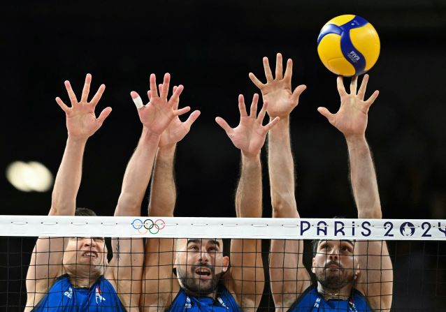 From left, Italy's Yuri Romano, Gianluca Galassi and Daniele Lavia jump to block the ball during the men's preliminary round volleyball match against Poland on August 3. Italy won the match 3-1.