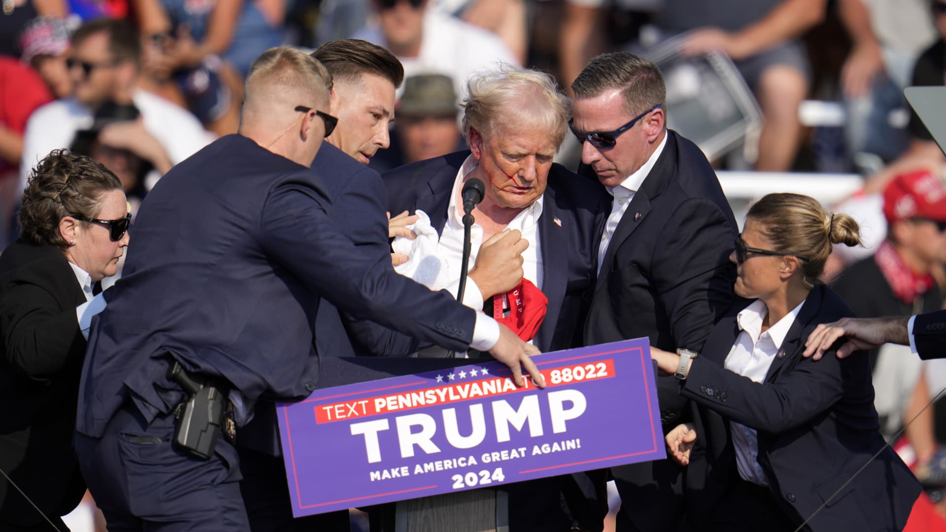 Photos show Trump with blood on his face after shots fired at rally