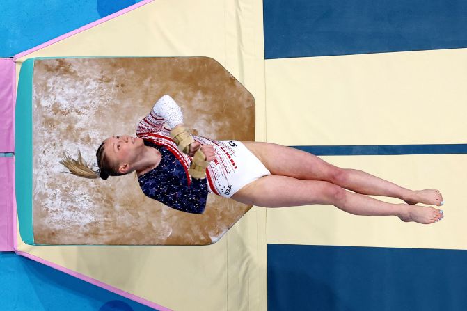 Carey soars through the air during her vault at the start of the team gymnastics competition.