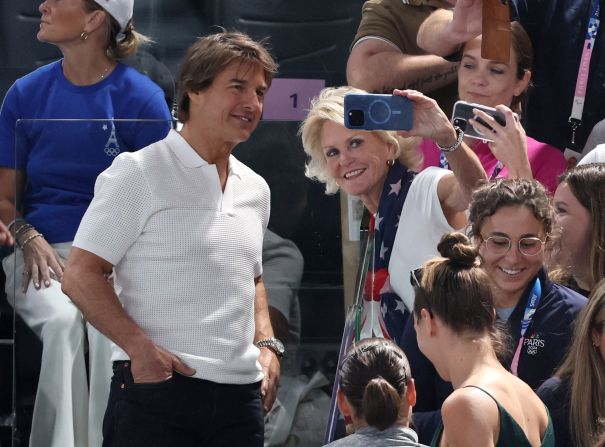 Actor Tom Cruise takes a photo with a fan during the women's gymnastics qualification round on July 28. <a href="https://www.cnn.com/sport/live-news/paris-olympics-news-2024-07-28#h_0f096a6923ada737f3dadf40a552b03b">Other celebrities watching</a> included Snoop Dogg and Ariana Grande.